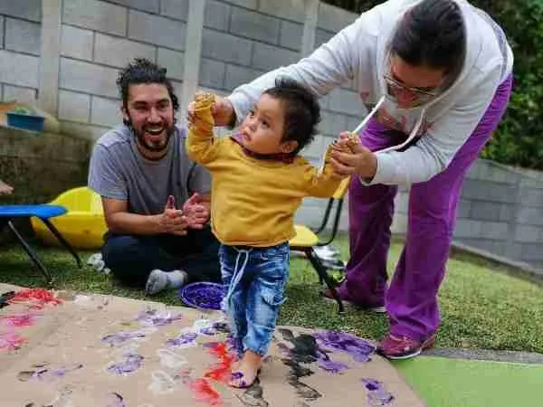 Workers helping disabled child